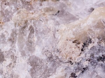 Macro minerals spodumene stone on a white background